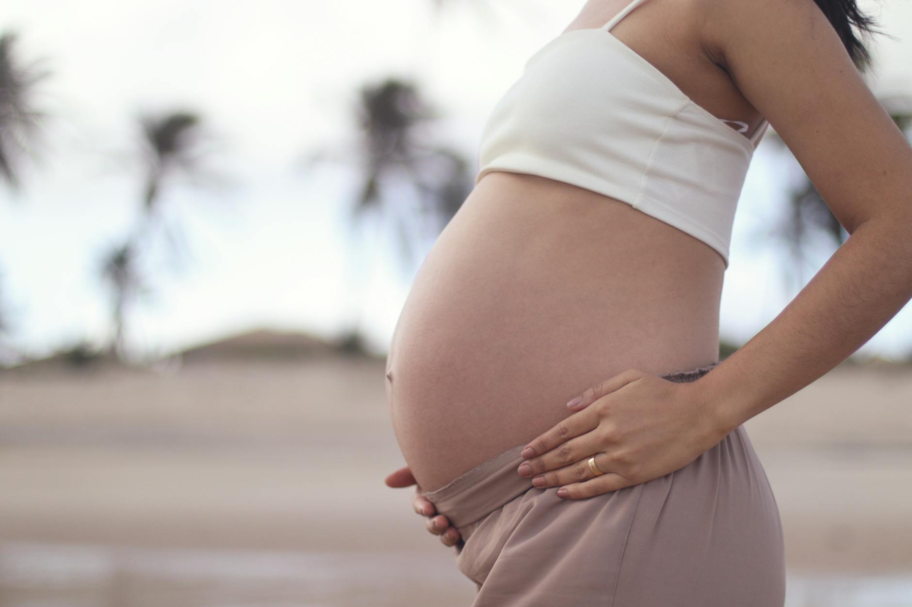 pregnant woman posing at beachside